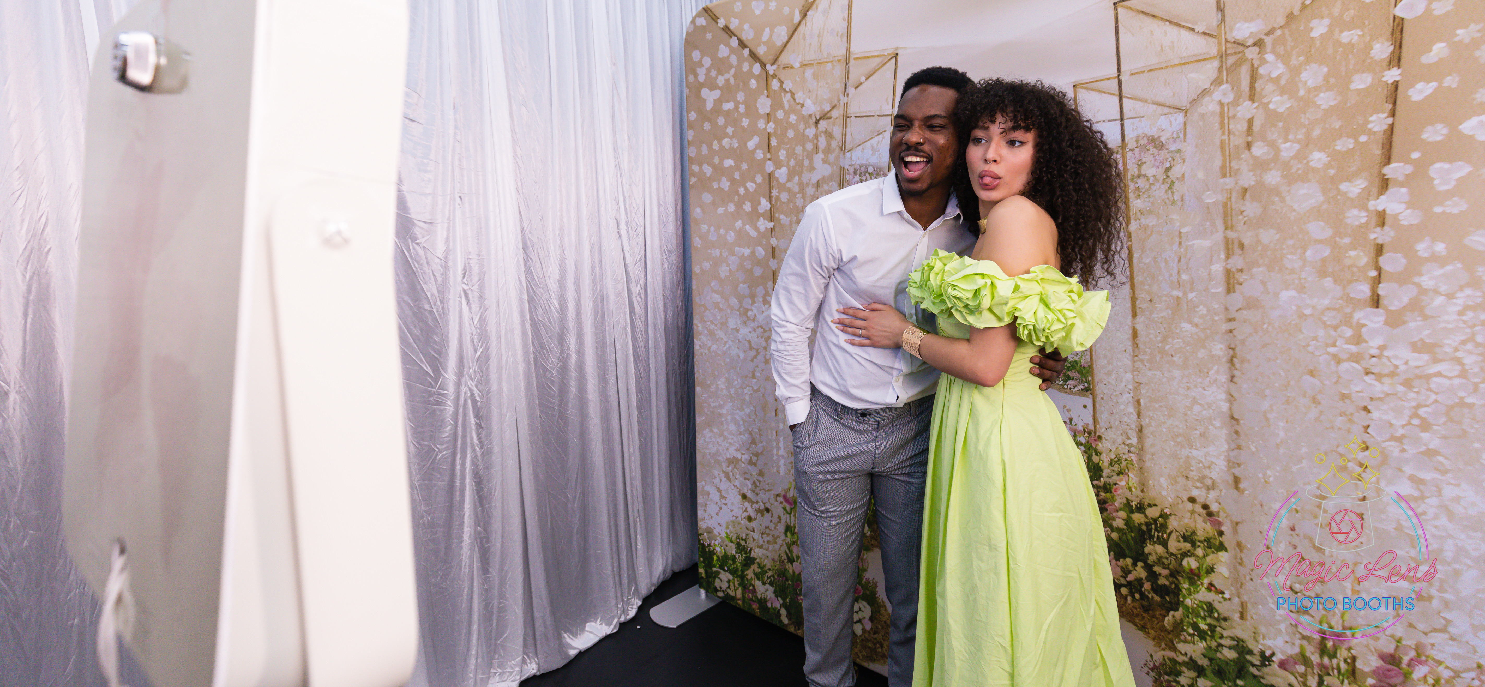 Young people at a wedding or party, posing for photos on the La Party Photo booth in front of a white backdrop