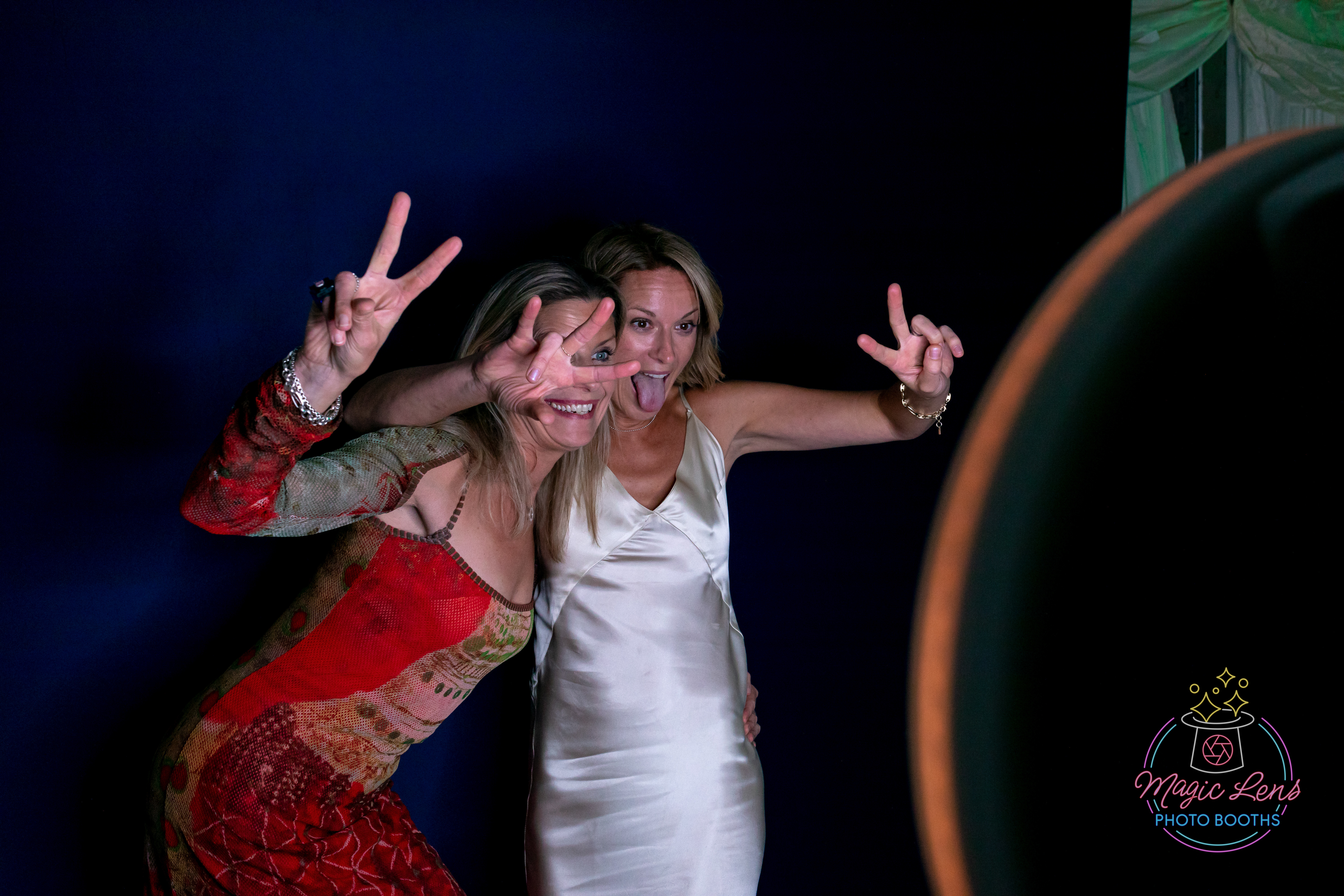 Pretty ladies having fun posing in front of the Mobi Aura for photos